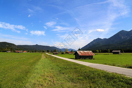 夏季阿尔卑斯山绿色草地上的山间小屋高清图片