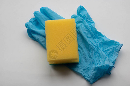 浅色背景上的橡胶手套和厨房海绵洗涤海绵和防护手套清图片