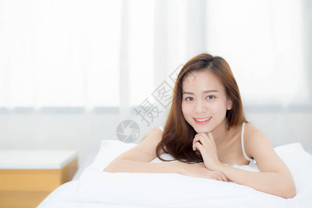 美丽的肖像年轻亚洲女躺在床上图片