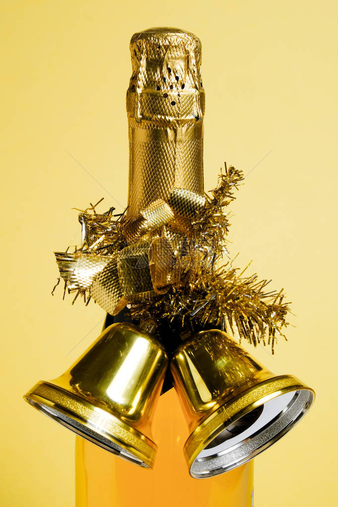 一瓶圣诞香槟和金色圣诞钟图片