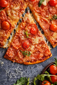 薄荷披萨和樱桃西红柿的切片在灰石背景上切成美图片