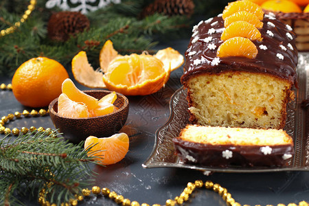 含橘子涂有巧克力冰霜的杯饼位于新年的背景横向方近视上图片