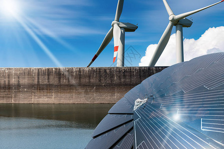可再生能源带有太阳能电池板的阳光与风力涡轮机的风雨图片