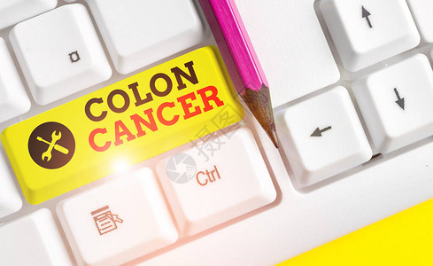 手写文本结肠癌结肠或直肠癌细胞发展的概念照片白色pc键盘背景图片