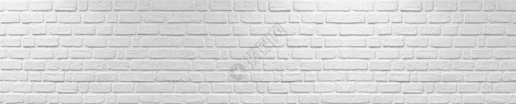 白色的水泥石膏墙由砖块制成图片
