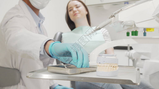专业牙医检查女患者的牙齿图片