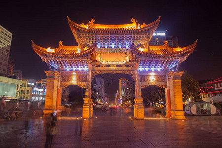 云南民族村大门和许多人正在云南省昆明市观光访问背景图片