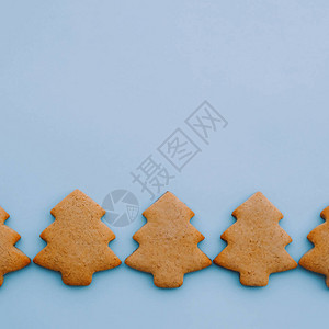浅蓝色背景上圣诞树形状的节日饼干文本的空间最小的组成图片