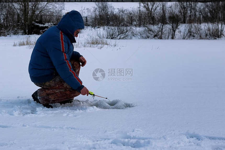 冬季湖上钓鱼的老人图片