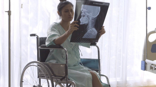 重病患者在看她的脑损伤手术的X光图像图片