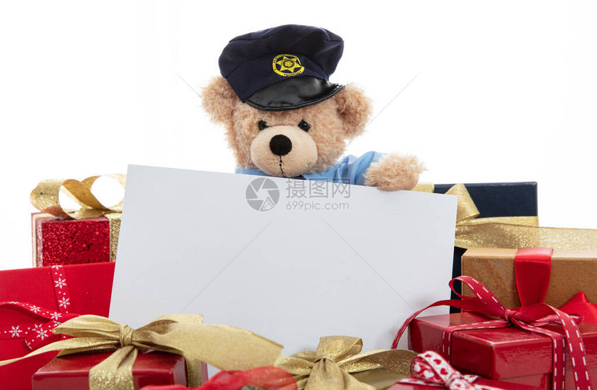 警察和圣诞节的概念穿着警服的可爱泰迪熊和白色背景中突显的圣诞礼图片