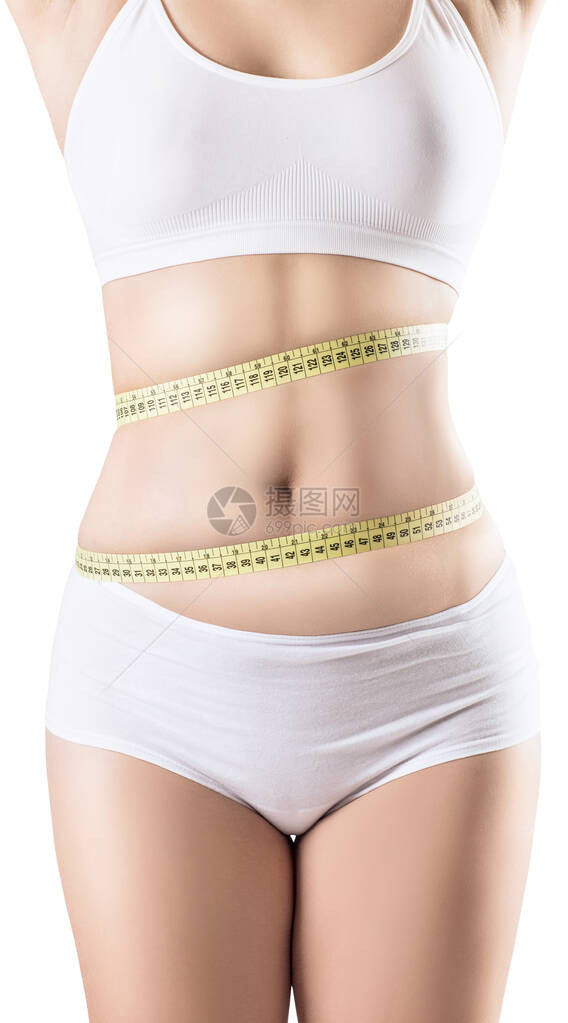 女人在体重减退后测量她的肚子肥胖的概念图片