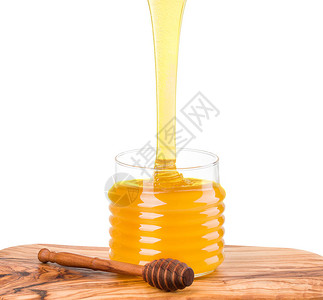玻璃罐装满了蜂蜜和木板上的木板图片