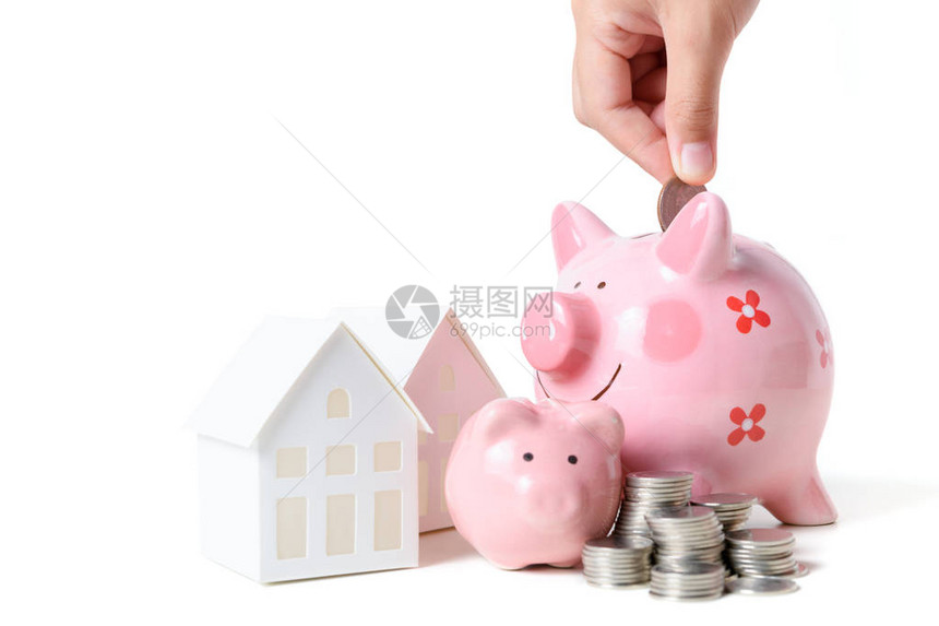 手把硬币存到小猪银行存钱买新房子用白种背景图片