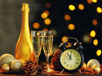 闹钟圣诞装饰和香槟在桌边与图片