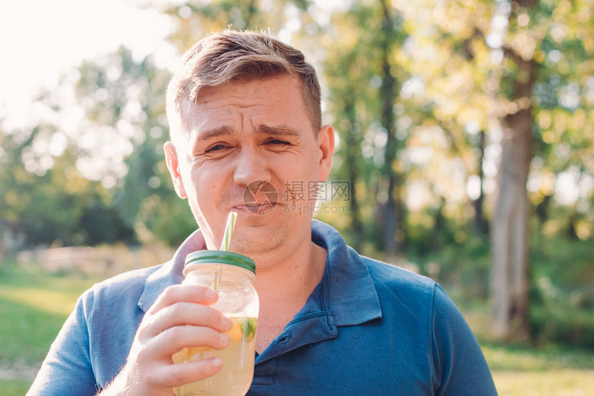 一个户外男人沉浸在大自然中喝杯自制柠檬水图片