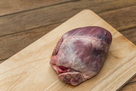 厨房木制切菜板上的新鲜猪心图片
