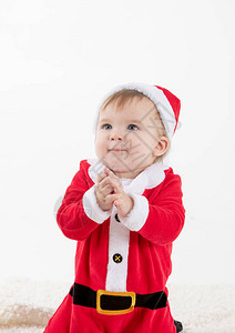 挂着一个工作室的垂直照片里面有白色的婴儿背景打扮成圣诞图片