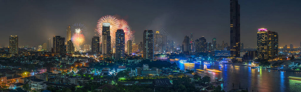 梦幻般的多色烟花在曼谷城市景观河边的全景上爆炸图片