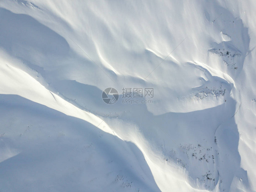 山区雪层覆盖地形的空中观察图片