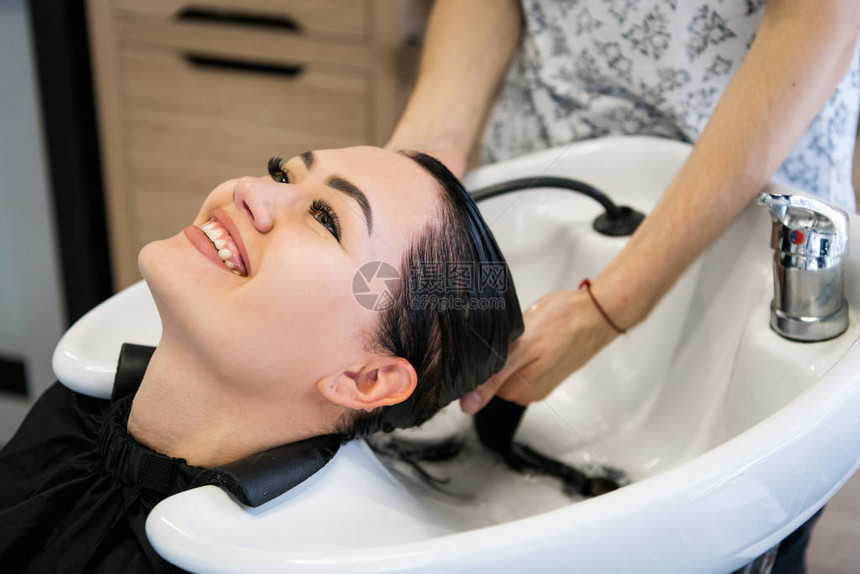 女人在温泉沙龙接受理发治疗用洗发水做头发图片