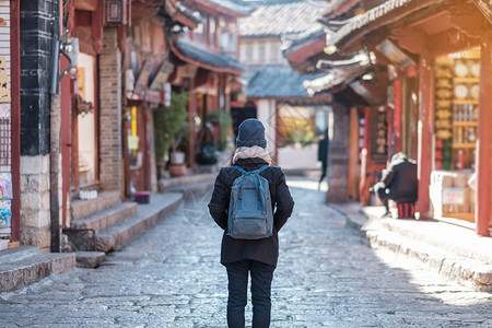 年轻女子旅行者在丽江古城广场街旅行图片