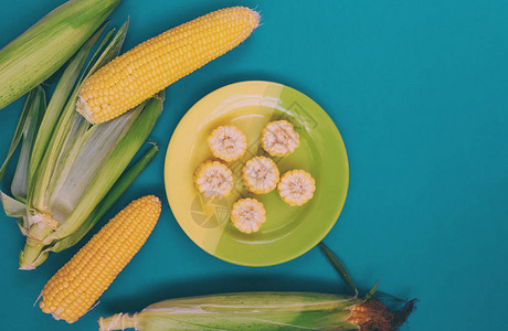 绿松石背景上的玉米盘玉米片谷物产品一盘玉米图片
