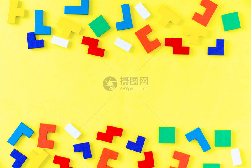 黄色背景上五颜六色的不同形状木块的框架天然的儿童玩具创意逻辑思维概念平图片