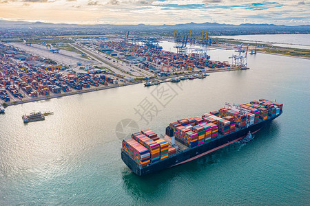 收货人大型TEU集装箱船到达和离开港口的顶部鸟瞰图背景