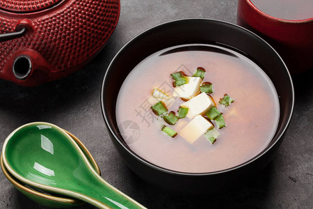 传统日本豆腐和春洋葱汤碗里有茶图片