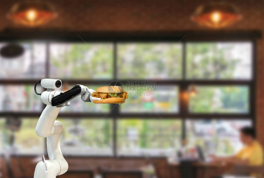 智能机器人食品在餐厅里拿着汉堡包未来机器人自图片