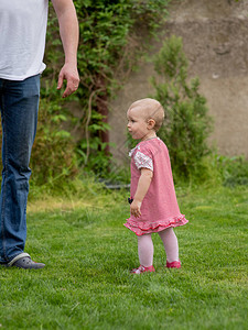 小孩1岁的女婴去父亲带着孩子穿过绿草婴儿在父母的支持下学会走路1岁的女孩和爸生活方图片