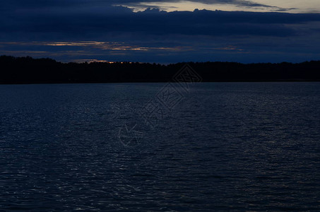 日落时分湖滩上空的风暴云图片