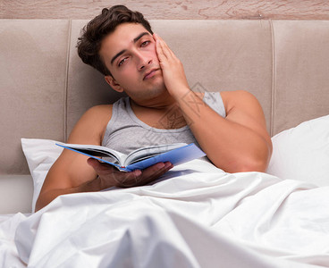 躺在床上看书的男人图片