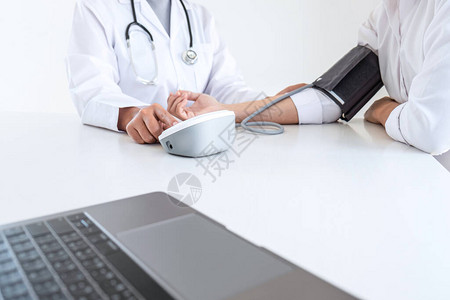 医生使用血压计和听诊器检查在医院医疗保健和医疗概念中测量手臂图片
