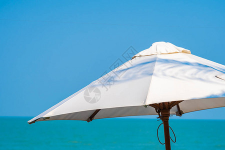 围绕海滩洋美丽的热带自然的白伞图片