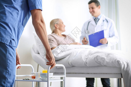 护士在医院病房特闭室为病人送药的现用推图片