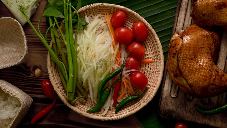 索姆图或木瓜沙拉泰国传统食物和鸡肉烤在木图片