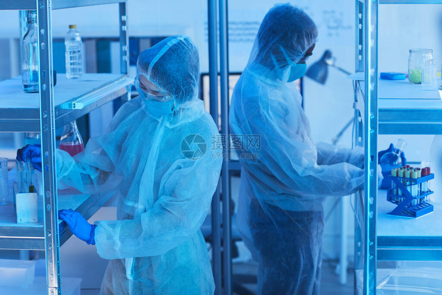 两名从事防护服开发新疫苗的无法辨认科学家的横向中长高角射图片