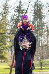 快乐的父亲和他的女儿在公园里玩耍在户外图片
