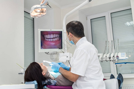 病人和牙医在牙科看屏幕图片