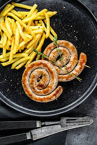 传统的德国猪肉螺旋烤香肠和一盘薯条图片