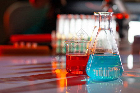 发光的实验室烧瓶里放着五颜六色的化学溶液图片
