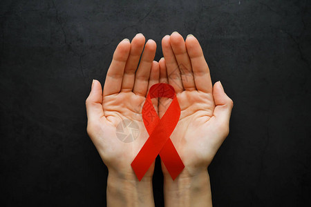 人类免疫缺陷的象征红带伸出援助之手背景图片