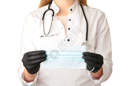 医生用黑色手套握着白色背景的医保面罩图片