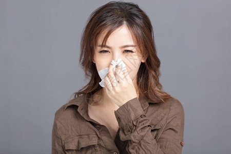 生病的年轻女人擤鼻涕图片