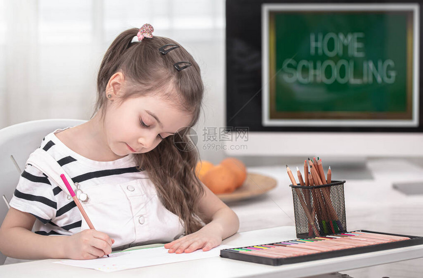 这个女孩正坐在桌旁做作业孩子在家学习在家上学图片