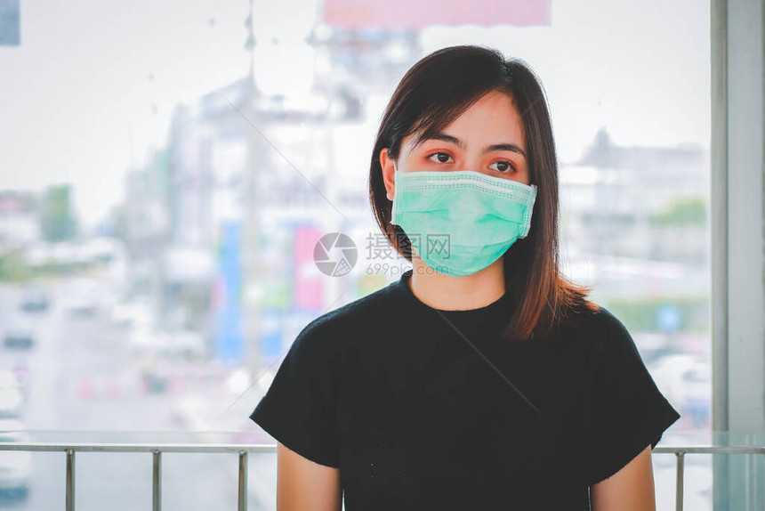 身戴面具保护Pm25和咳嗽的亚裔女在公共场合爆发Covi图片