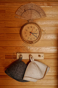 挂在钟头和风扇上面的木架上的帽子浴饰件图片