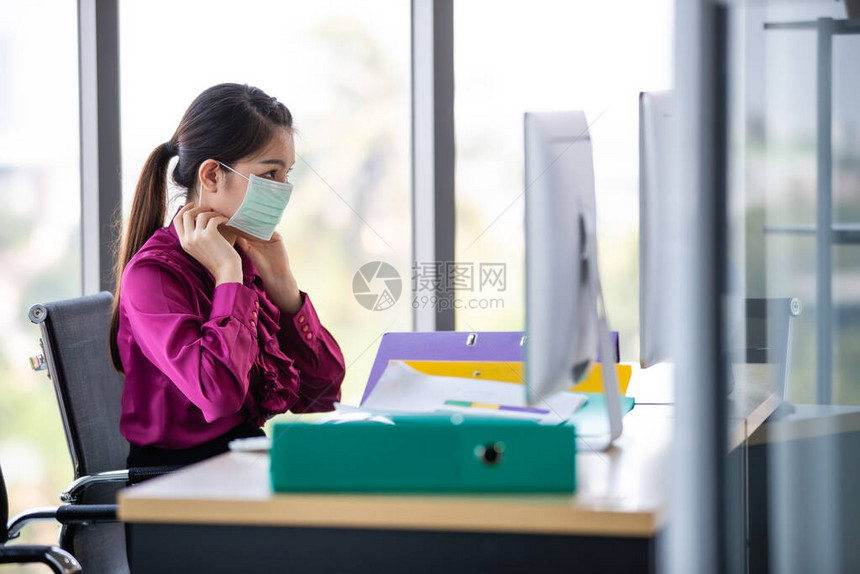 女员工在她的脸上戴外科卫生口罩图片